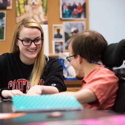 Therapeutic recreation student working on a project with a person